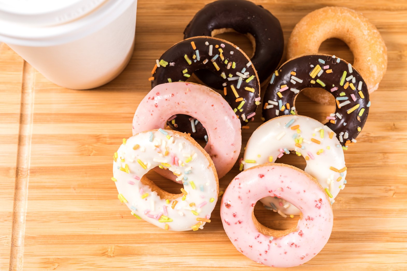 Donuts and Coffee on Wooden Table.